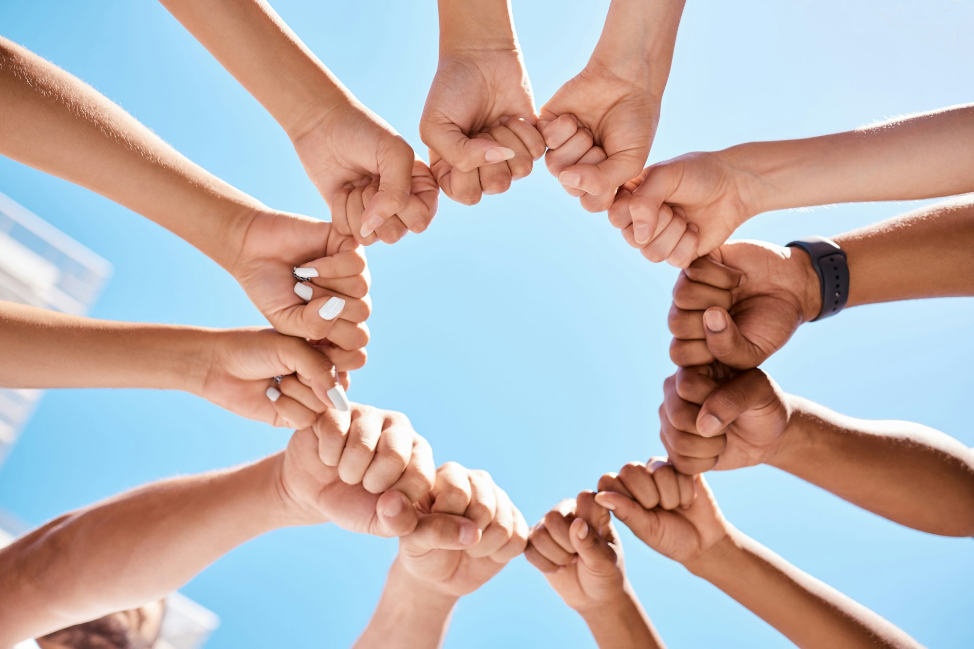 Fist hands, circle and community support diversity people, protest group and freedom fight on blue